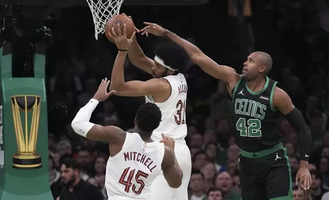 Boston Celtics center Al Horford (42) battles for a rebound against Cleveland Cavaliers center Jarrett Allen (31) during the first half of an Emirates NBA Cup basketball game, Tuesday, Nov. 19, 2024, in Boston. (AP Photo/Charles Krupa)