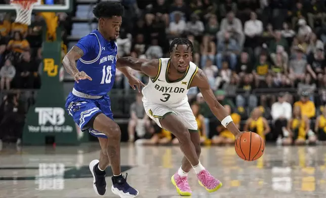 Baylor guard Jeremy Roach (3) works to the basket as New Orleans's Dae Dae Hunter (10) defends in the first half of an NCAA college basketball game Wednesday, Nov. 27, 2024, in Waco, Texas. (AP Photo/Tony Gutierrez)