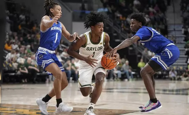 Baylor guard Robert Wright III (1) works to make a pass as New Orleans's JR Jacobs (1) and Jah Short, right, defend in the first half of an NCAA college basketball game Wednesday, Nov. 27, 2024, in Waco, Texas. (AP Photo/Tony Gutierrez)