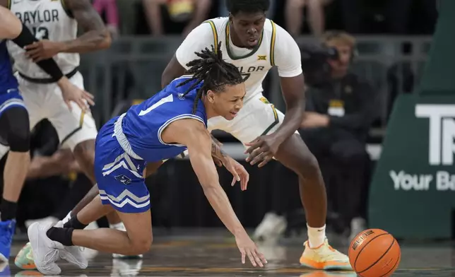 New Orleans guard JR Jacobs (1) loses control of the ball as Baylor's Josh Ojianwuna, rear, defends in the first half of an NCAA college basketball game Wednesday, Nov. 27, 2024, in Waco, Texas. (AP Photo/Tony Gutierrez)