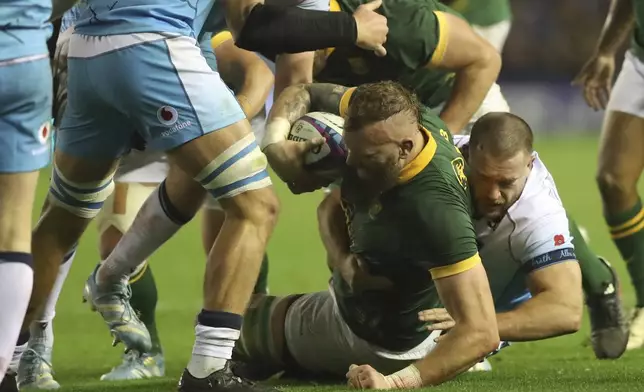 South Africa's RG Snyman, is brought down by Scotland's Josh Bayliss during the Autumn Nations series rugby union match between Scotland and South Africa in Edinburgh, Scotland, Sunday, Nov. 10, 2024. (AP Photo/Scott Heppell)