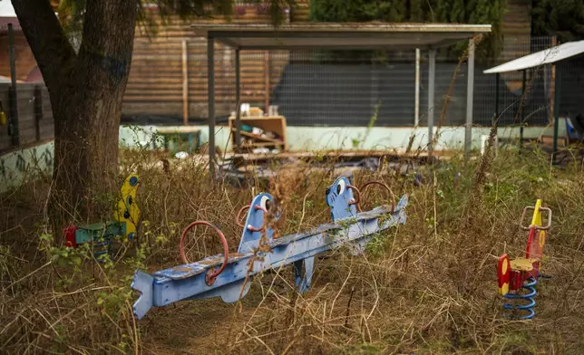 The weeds grow in a deserted kindergarten playground in Shlomi, northern Israel, near to the border with Lebanon, Wednesday, Nov. 27, 2024. (AP Photo/Francisco Seco)