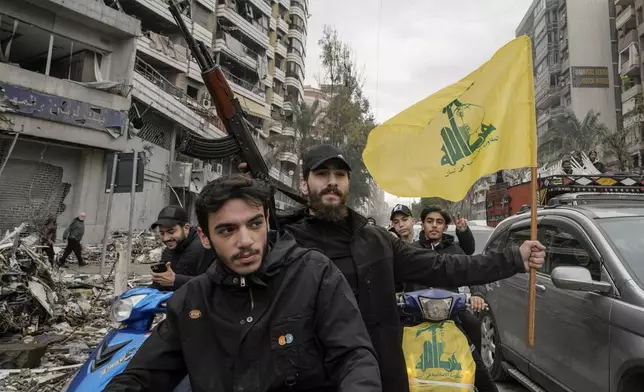 Hezbollah supporters celebrate as they return to Dahiyeh, in Beirut, Lebanon, following a ceasefire between Israel and Hezbollah that went into effect on Wednesday, Nov. 27, 2024. (AP Photo/Bilal Hussein)