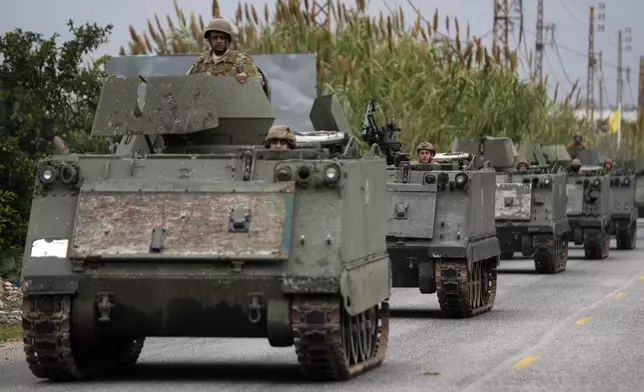 Lebanese soldiers ride in a convoy in Mansouri, as they head to southern Lebanon, following a ceasefire between Israel and Hezbollah that went into effect on Wednesday, Nov. 27, 2024. (AP Photo/Hussein Malla)