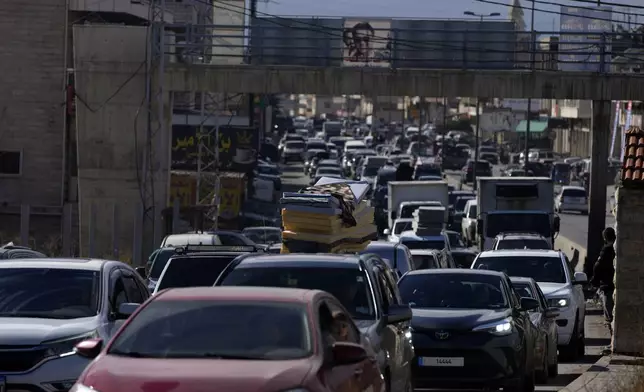 Displaced residents sit in traffic as they return to their villages following a ceasefire between Israel and Hezbollah that went into effect on Wednesday, Nov. 27, 2024, in Ablah, eastern Lebanon. (AP Photo/Hassan Ammar)