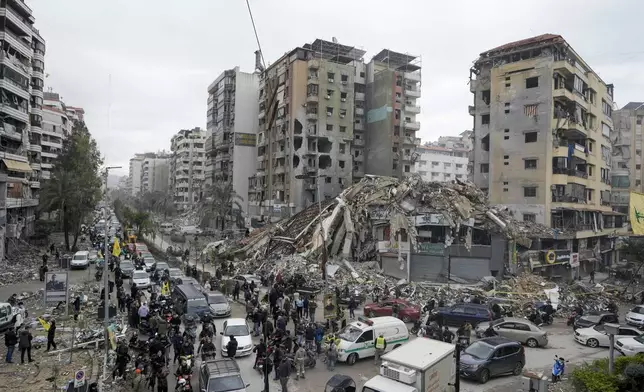 Displaced residents return to Dahiyeh, in Beirut, Lebanon, following a ceasefire between Israel and Hezbollah that went into effect on Wednesday, Nov. 27, 2024. (AP Photo/Bilal Hussein)