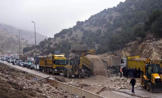 Displaced residents returning from Syria sit in traffic as roadworks get underway to reopen the Masnaa border crossing, eastern Lebanon, following a ceasefire between Israel and Hezbollah on Wednesday, Nov. 27, 2024. (AP Photo/Hassan Ammar)