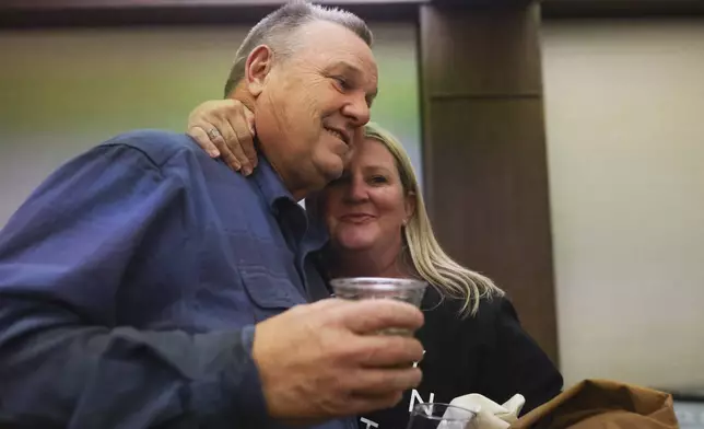 FILE - Sen. Jon Tester, D-Mont., left, receives a hug from supporter Brianne Laurin during an election night watch party, Nov. 5, 2024, in Great Falls, Mont. (AP Photo/Mike Clark, File)