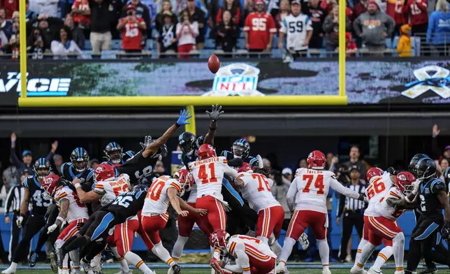 Kansas City Chiefs place kicker Spencer Shrader (40) kicks the game-winning field goal in overtime during an NFL football game against the Carolina Panthers, Sunday, Nov. 24, 2024, in Charlotte, N.C. (AP Photo/Rusty Jones)