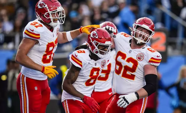 Kansas City Chiefs wide receiver DeAndre Hopkins (8) celebrates his touchdown catch with teammates during the second half of an NFL football game against the Carolina Panthers, Sunday, Nov. 24, 2024, in Charlotte, N.C. (AP Photo/Rusty Jones)