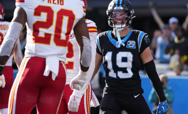 Carolina Panthers wide receiver Adam Thielen (19) speaks with Kansas City Chiefs safety Justin Reid (20) after a two-point conversion attempt during the second half of an NFL football game, Sunday, Nov. 24, 2024, in Charlotte, N.C. Reid was called for a persoanl foul against Thielen. (AP Photo/Rusty Jones)