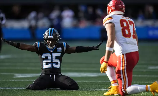 Carolina Panthers safety Xavier Woods (25) celebrates breaking up a pass intended for Kansas City Chiefs tight end Travis Kelce (87) during the second half of an NFL football game, Sunday, Nov. 24, 2024, in Charlotte, N.C. (AP Photo/Rusty Jones)