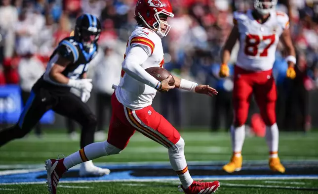 Kansas City Chiefs quarterback Patrick Mahomes (15) runs down field against the Carolina Panthers during the first half of an NFL football game, Sunday, Nov. 24, 2024, in Charlotte, N.C. (AP Photo/Jacob Kupferman)