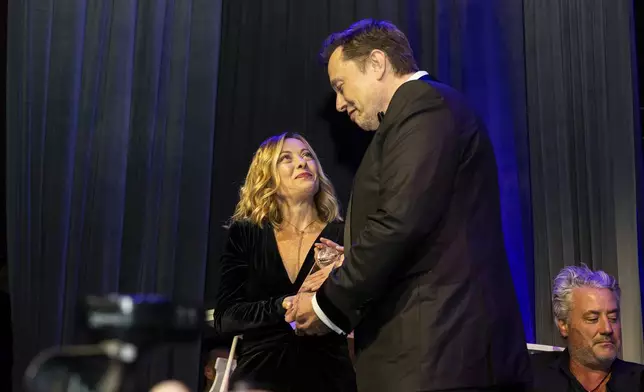 CORRECTS TO PRIME MINISTER, NOT PRESIDENT - FILE - Elon Musk, CEO of Tesla, right, presents Italy's Prime Minister Giorgia Meloni with an award during the Global Citizen Awards dinner, Monday, Sept. 23, 2024, in New York. (AP Photo/Michelle Farsi, File)