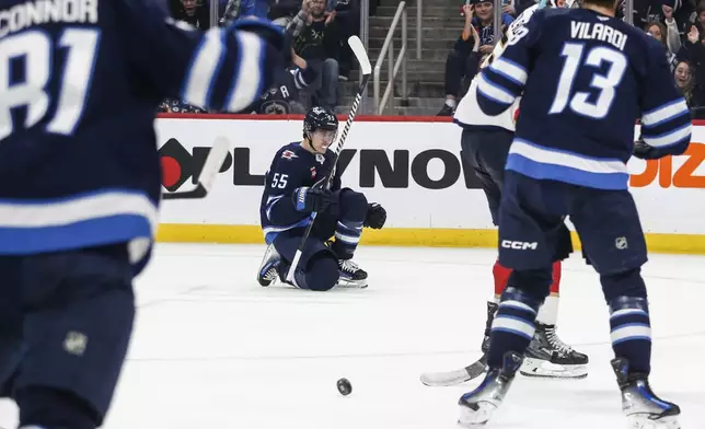 Winnipeg Jets' Mark Scheifele (55) celebrates his goal against the Florida Panthers during the second period of an NHL hockey game in Winnipeg, Manitoba, Tuesday, Nov. 19, 2024. (Fred Greenslade/The Canadian Press via AP)