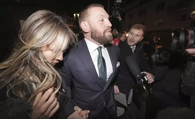 Mixed martial arts fighter Conor McGregor and partner Dee Devlin leave the High Court in Dublin, Ireland, Friday Nov. 22, 2024. (Brian Lawless/PA via AP)