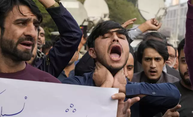 Shiite Muslims chant slogans to condemn the killing of Shiite Muslims by gunmen in an ambush in Kurram district, during a demonstration in Lahore, Pakistan, Friday, Nov. 22, 2024. (AP Photo/K.M. Chaudary)