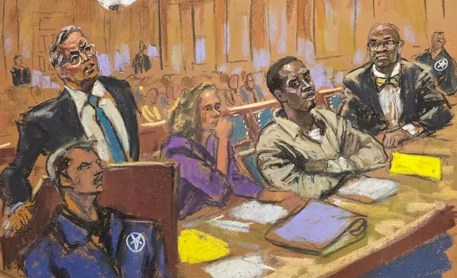 In this courtroom sketch, attorney Marc Agnifolo, left, speaks at the podium, as Alexandra Shapiro, Sean Diddy Combs, and attorney Tony Riccio, seated second left to right, listen during a hearing in federal court, Friday, Nov. 24, 2024, in New York. (Jane Rosenberg via AP)