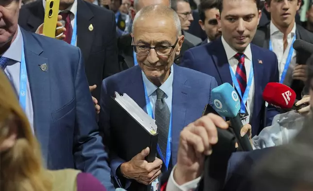 John Podesta, U.S. climate envoy, walks through a crowd during the COP29 U.N. Climate Summit, Saturday, Nov. 23, 2024, in Baku, Azerbaijan. (AP Photo/Peter Dejong)