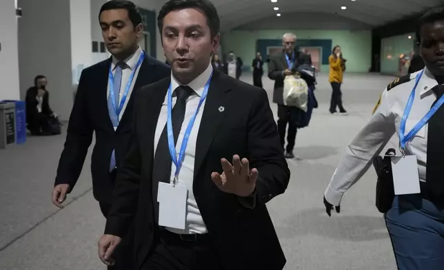 Yalchin Rafiyev, Azerbaijan's COP29 lead negotiator, gestures as he walks through the COP29 U.N. Climate Summit, Saturday, Nov. 23, 2024, in Baku, Azerbaijan. (AP Photo/Rafiq Maqbool)