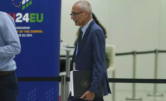 John Podesta, U.S. climate envoy, walks in the hallway during the COP29 U.N. Climate Summit, Saturday, Nov. 23, 2024, in Baku, Azerbaijan. (AP Photo/Peter Dejong)