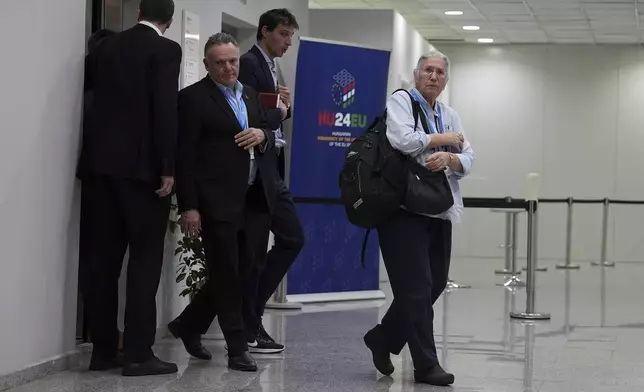 U.S. Deputy Climate Envoy Sue Biniaz, right, and Wopke Hoekstra, EU climate commissioner, second from right, walk out of an elevator during the COP29 U.N. Climate Summit in the early hours of Saturday, Nov. 23, 2024, in Baku, Azerbaijan. (AP Photo/Joshua A. Bickel)