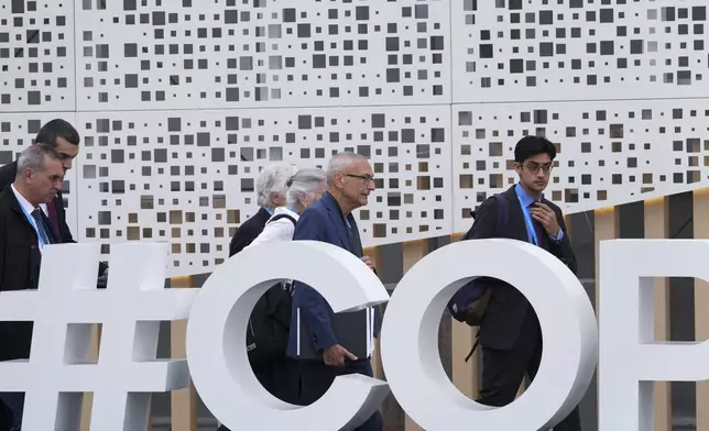 John Podesta, U.S. climate envoy, center right, and U.S. Deputy Climate Envoy Sue Biniaz, center, walk outside the venue for the COP29 U.N. Climate Summit, Saturday, Nov. 23, 2024, in Baku, Azerbaijan. (AP Photo/Sergei Grits)