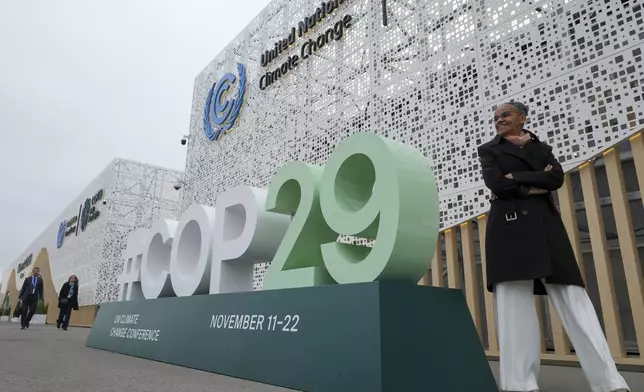 Marina Silva, Brazil environment minister, stands near a sign for the COP29 U.N. Climate Summit, Saturday, Nov. 23, 2024, in Baku, Azerbaijan. (AP Photo/Sergei Grits)