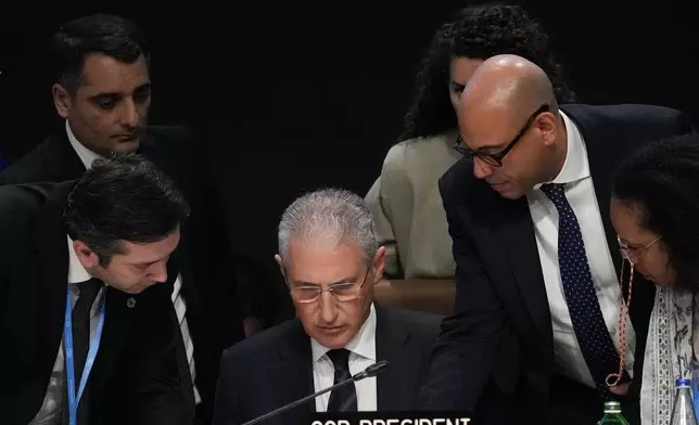 Yalchin Rafiyev, Azerbaijan's COP29 lead negotiator, left, Mukhtar Babayev, COP29 President, center, and Simon Stiell, United Nations climate chief, talk ahead of a plenary session at the COP29 U.N. Climate Summit, Sunday, Nov. 24, 2024, in Baku, Azerbaijan. (AP Photo/Rafiq Maqbool)