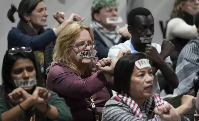 Activists participate in a demonstration for climate finance at the COP29 U.N. Climate Summit, Saturday, Nov. 23, 2024, in Baku, Azerbaijan. (AP Photo/Sergei Grits)
