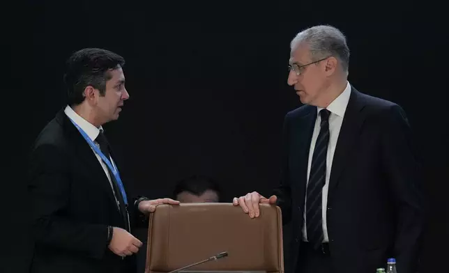 Yalchin Rafiyev, Azerbaijan's COP29 lead negotiator, left, talks to Mukhtar Babayev, COP29 President, ahead of a plenary session at the COP29 U.N. Climate Summit, Sunday, Nov. 24, 2024, in Baku, Azerbaijan. (AP Photo/Rafiq Maqbool)