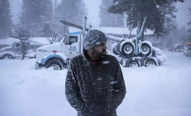 Truck driver Harry Singh of Seattle looks down Shastina Drive where several dozen big rigs were gathered after being stuck overnight in Weed, Calif., Wednesday, Nov. 20, 2024. (Carlos Avila Gonzalez/San Francisco Chronicle via AP)