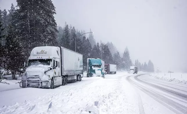 Truckers hole up along the side of I-5 to let the storm pass before the highway is reopened in Weed, Calif., Wednesday, Nov. 20, 2024. (Carlos Avila Gonzalez/San Francisco Chronicle via AP)