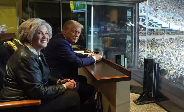 FILE - Republican presidential nominee former President Donald Trump sits with Susie Wiles as he attends the New York Jets football game against the Pittsburgh Steelers at Acrisure Stadium, Oct. 20, 2024, in Pittsburgh. (AP Photo/Evan Vucci, File)