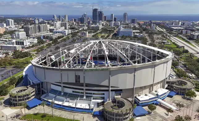 FILE - The roof of the Tropicana Field is damaged the morning after Hurricane Milton hit the region, Oct. 10, 2024, in St. Petersburg, Fla. (AP Photo/Mike Carlson, File)