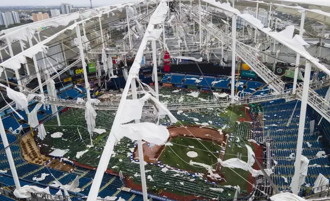 FILE - The roof of the Tropicana Field is damaged the morning after Hurricane Milton hit the region, Oct. 10, 2024, in St. Petersburg, Fla. (AP Photo/Julio Cortez, File)