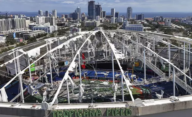 FILE - The roof of the Tropicana Field is damaged the morning after Hurricane Milton hit the region, Thursday, Oct. 10, 2024, in St. Petersburg, Fla. (AP Photo/Mike Carlson, File)