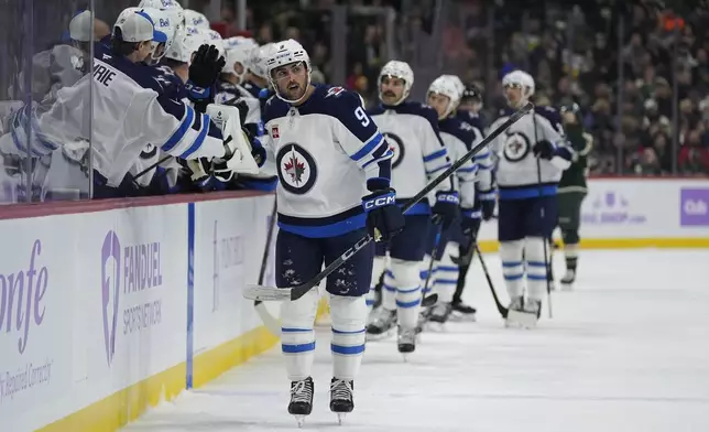 Winnipeg Jets left wing Alex Iafallo (9) celebrates after scoring during the first period of an NHL hockey game against the Minnesota Wild, Monday, Nov. 25, 2024, in St. Paul, Minn. (AP Photo/Abbie Parr)