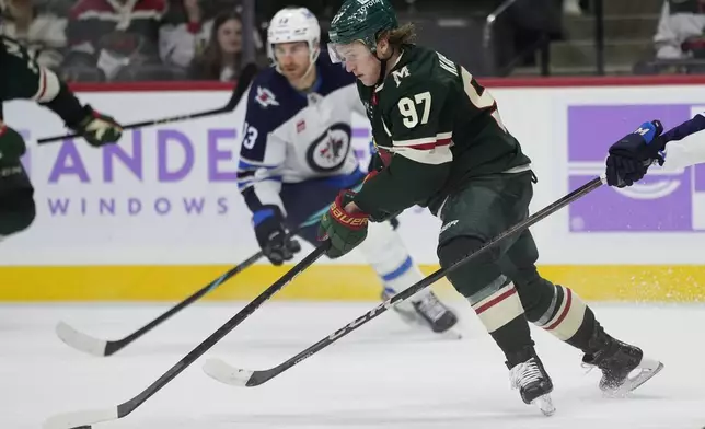 Minnesota Wild left wing Kirill Kaprizov (97) skates with the puck during the third period of an NHL hockey game against the Winnipeg Jets, Monday, Nov. 25, 2024, in St. Paul, Minn. (AP Photo/Abbie Parr)