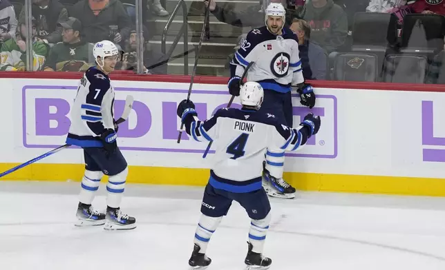 Winnipeg Jets right wing Nino Niederreiter (62) celebrates after scoring during the second period of an NHL hockey game against the Minnesota Wild, Monday, Nov. 25, 2024, in St. Paul, Minn. (AP Photo/Abbie Parr)