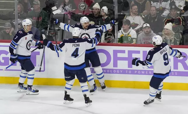 Winnipeg Jets right wing Nino Niederreiter (62),center back, celebrates after scoring during the second period of an NHL hockey game against the Minnesota Wild, Monday, Nov. 25, 2024, in St. Paul, Minn. (AP Photo/Abbie Parr)