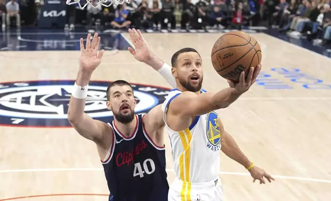 Golden State Warriors guard Stephen Curry, right, shoots as Los Angeles Clippers center Ivica Zubac defends during the second half of an NBA basketball game, Monday, Nov. 18, 2024, in Inglewood, Calif. (AP Photo/Mark J. Terrill)