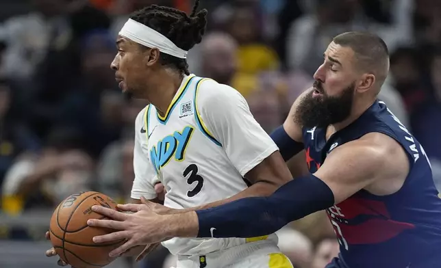 Indiana Pacers' Moses Brown goes to the basket against Washington Wizards' Jonas Valanciunas during the first half of an NBA basketball game, Sunday, Nov. 24, 2024, in Indianapolis. (AP Photo/Darron Cummings)