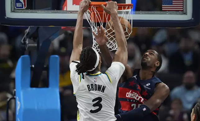 Indiana Pacers' Moses Brown (3) dunks against Washington Wizards' Alexandre Sarr, right, during the first half of an NBA basketball game, Sunday, Nov. 24, 2024, in Indianapolis. (AP Photo/Darron Cummings)