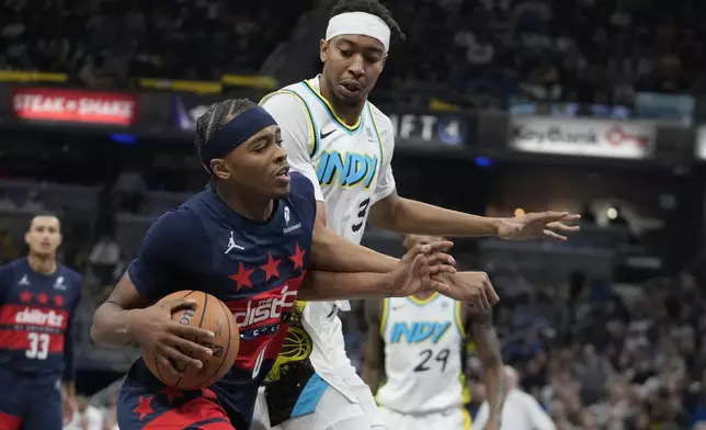 Washington Wizards' Bilal Coulibaly, front left, goes to the basket against Indiana Pacers's Moses Brown, front right, during the first half of an NBA basketball game, Sunday, Nov. 24, 2024, in Indianapolis. (AP Photo/Darron Cummings)