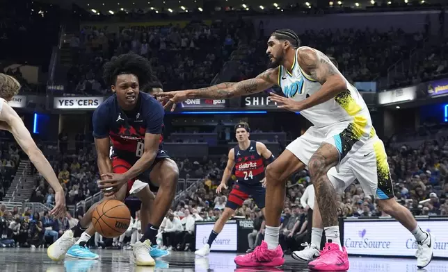 Washington Wizards' Carlton Carrington (8) is defended by Indiana Pacers' Obi Toppin, right, during the first half of an NBA basketball game, Sunday, Nov. 24, 2024, in Indianapolis. (AP Photo/Darron Cummings)