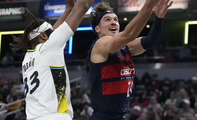 Washington Wizards' Corey Kispert, right, shoots against Indiana Pacers' Myles Turner, left, during the first half of an NBA basketball game, Sunday, Nov. 24, 2024, in Indianapolis. (AP Photo/Darron Cummings)