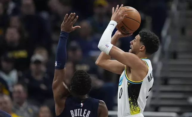 Indiana Pacers' Tyrese Haliburton (0) shoots against Washington Wizards' Jared Butler (4) during the first half of an NBA basketball game, Sunday, Nov. 24, 2024, in Indianapolis. (AP Photo/Darron Cummings)