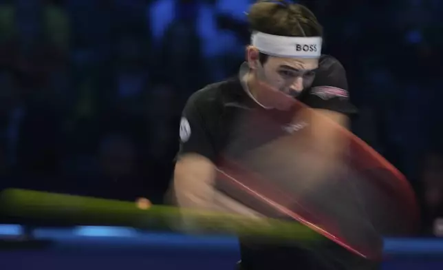 Taylor Fritz of the United States returns to Italy's Jannik Sinner during the final match of the ATP World Tour Finals at the Inalpi Arena, in Turin, Italy, Sunday, Nov. 17, 2024. (AP Photo/Antonio Calanni)