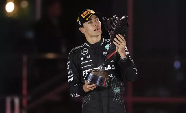 Mercedes driver George Russell, of Britain, celebrates on the podium after winning the F1 Las Vegas Grand Prix auto race, Sunday, Nov. 24, 2024, in Las Vegas. (AP Photo/Matt York)